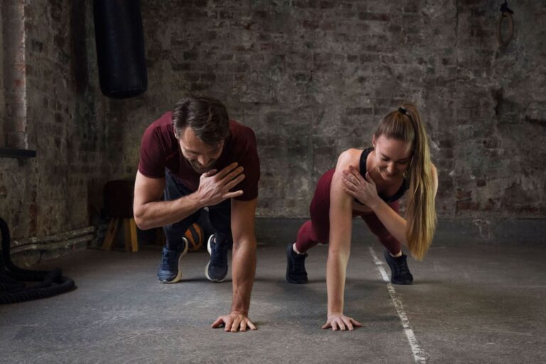 Man and woman doing calisthenics in a home gym